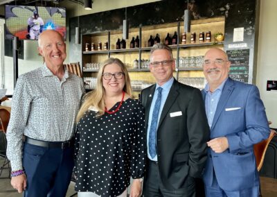 Jesse Coraggio (middle right) from Community Foundation Tampa Bay, with Ric Banciella (far right) from Children's Movement Florida in a photo with others at the engagement social event.