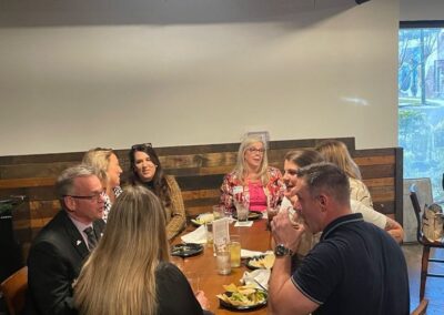 Attendees talk with food and beverage.
