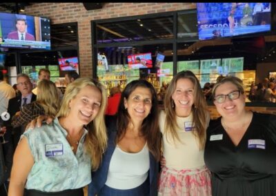 Diana Santanagelo, Director of Thrive by Five, poses for photos with attendees of the networking event.