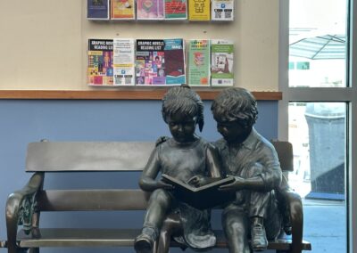 Statue of children reading at Largo Public Library.