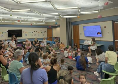 Diana Santangelo reading to toddlers and their caregivers.