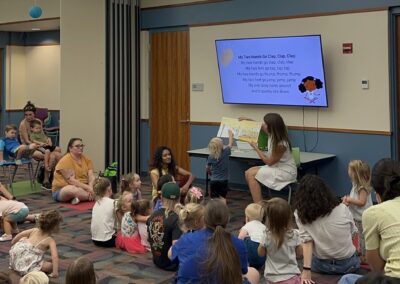 A child points at object on book during Thrive by Five Reads event.