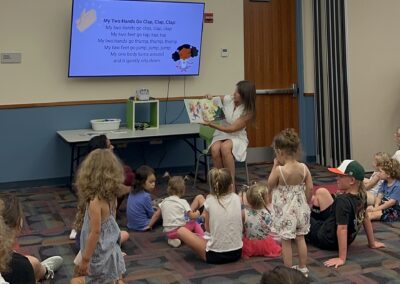 Kids lisetn as Diana Santangelo, Director of Thrive by Five, reads a book to them.